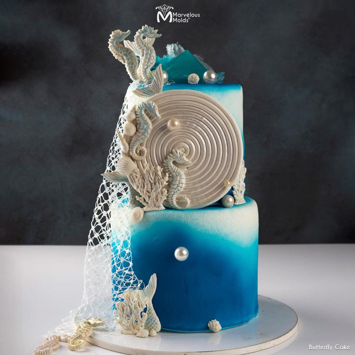 Underwater themed blue ocean cake with netting and shells, decorated with the Marvelous Molds Seahorse Mold