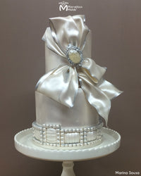 Elegant Bow and Brooch White Wedding Cake Decorated Using the Ritzy Brooch Silicone Mold by Marvelous Molds