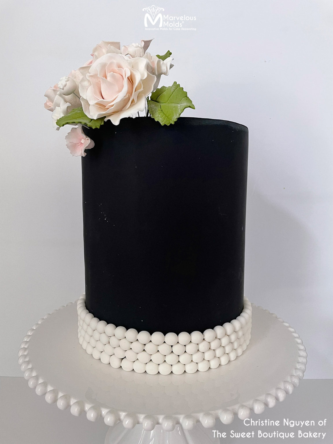 Pearl Wedding Cake decorated with detailed lace embroidery and pearls.