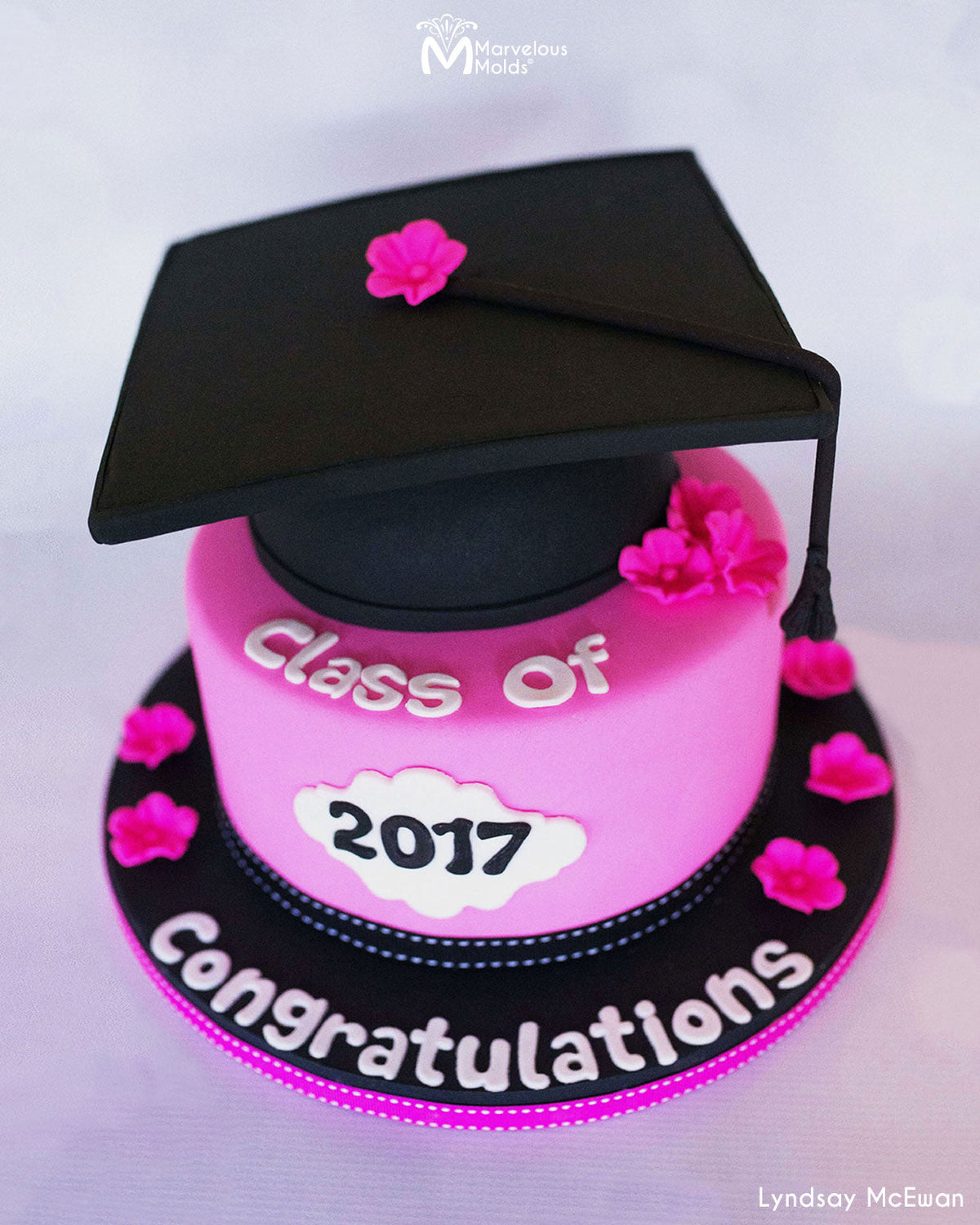 Pink Graduation Cap Cake decorated using the Bubble Lowercase Flexabet Letter Cutter by Marvelous Molds