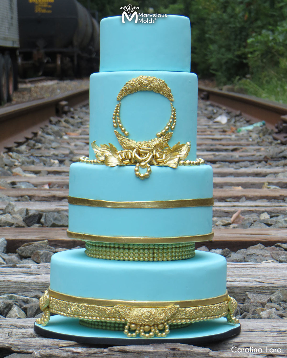 Turquoise Wedding Cake with Gold Embellishments Decorated using the Marvelous Molds Floral Swag Silicone Mold