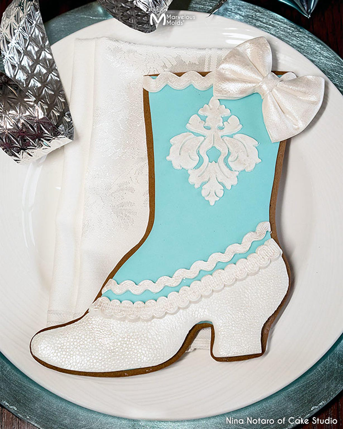 Shoe shaped cookie decorated using Marvelous Molds Damask Medallion Silicone Onlay