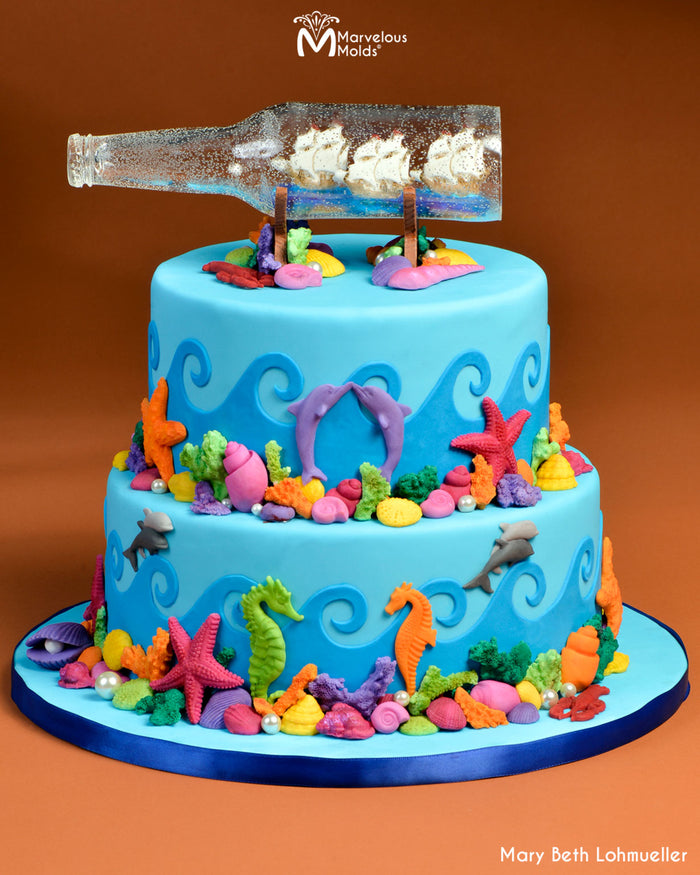 Ocean Themed Cake Decorated with a Ship in a Bottle, Created Using the USS Marvelous Silicone Boat Mold by Marvelous Molds