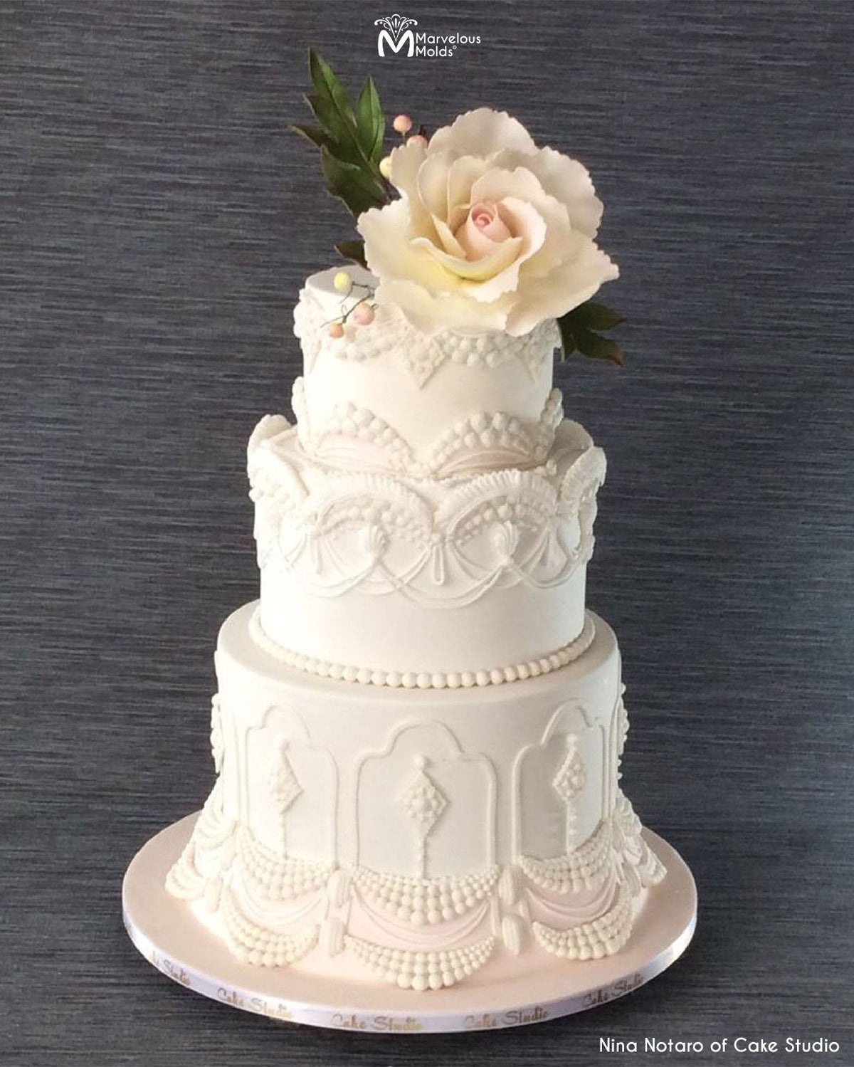 White Wedding Cake decorated using the Classic Pearl Swag by Marvelous Molds