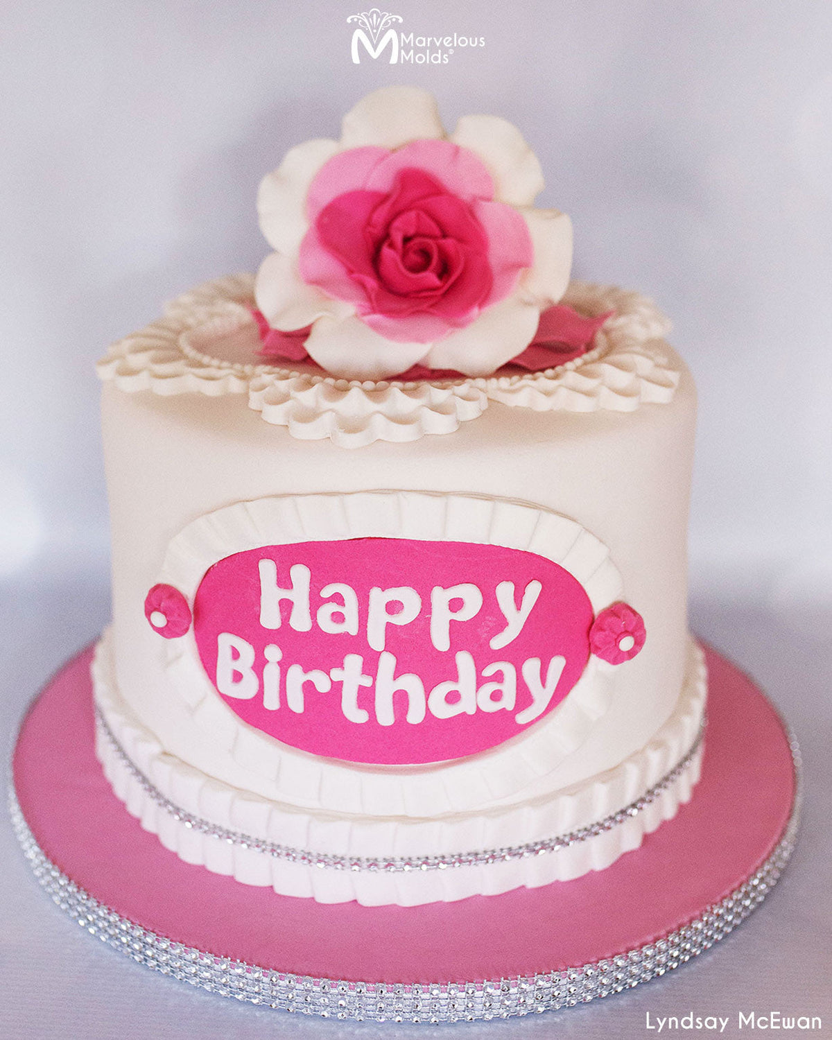 Pink Pleated Birthday cake decorated using the Bubble Happy Birthday Flexabet Letter Cutter by Marvelous Molds