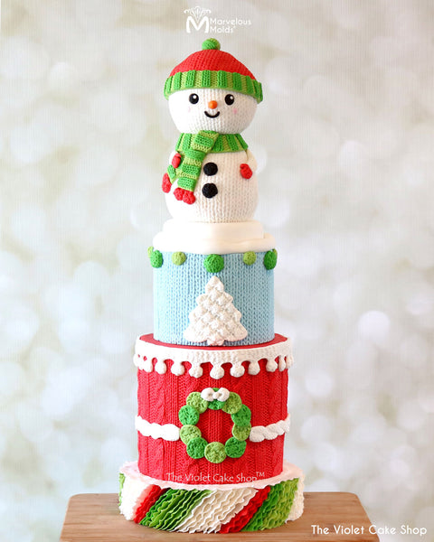 Knitted Festive Holiday Cake with a Knit Snowman Topper, Created Using the Marvelous Molds Pom Pom Knit Border Mold with Fondant
