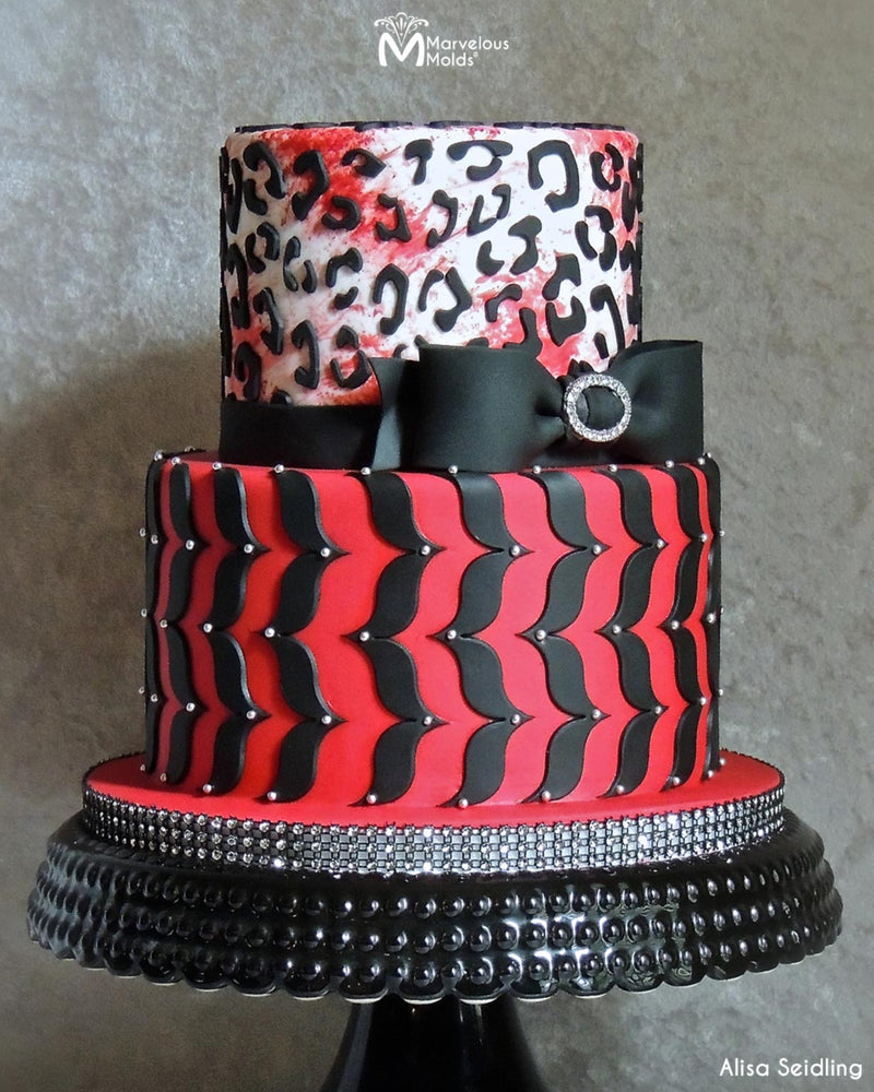 Leopard Print Red and Black Cake Decorated Using the Marvelous Molds Leopard Silicone Onlay Cake Stencil