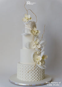 Modern Off-White Wedding Cake with Floral Toppers and a Ruffle Pattern on the Bottom Tier, Decorated using the Marvelous Molds Ribbon Ruffle Simpress Silicone Mold