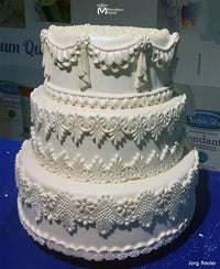 White Wedding Cake Bordered with the Draped Ruffle Drop Mold made by Marvelous Molds