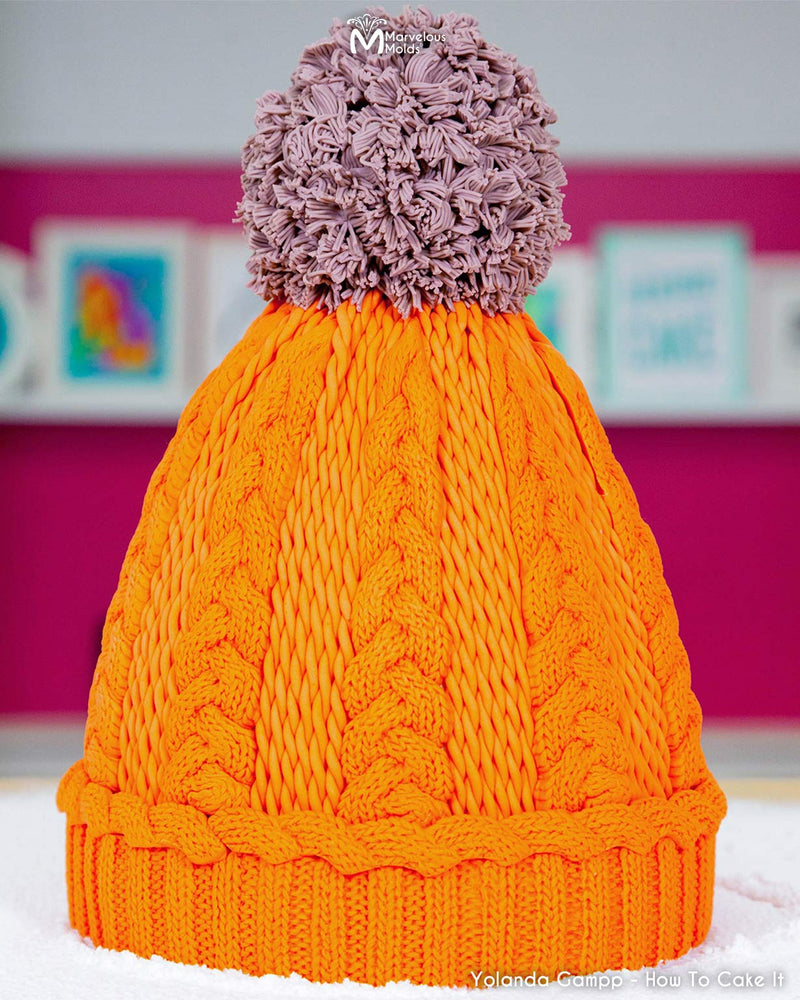 Winter Pom Pom Beanie Decorated Using the Marvelous Molds Ribbed Knit Border Silicone Mold for Cake Decorating