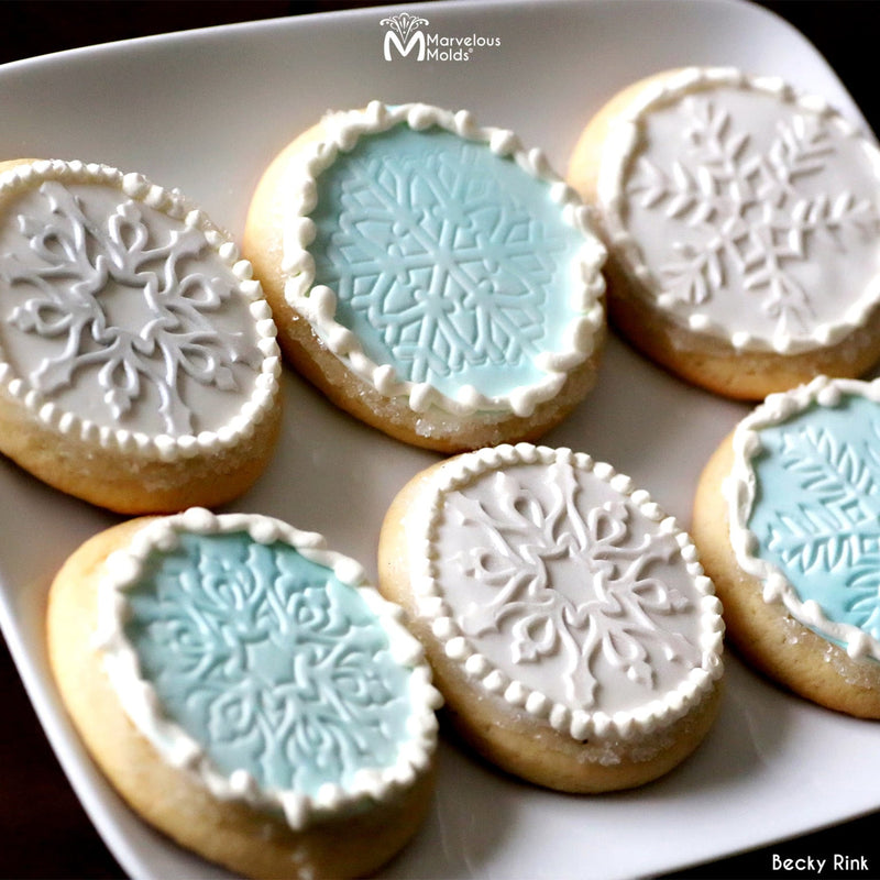 Winter themed Snowflake Cookies Decorated using Marvelous Molds Dasher Cakeflake Stencil